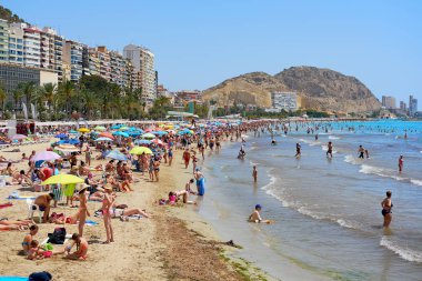 Alicante, İspanya - 26 Haziran 2018: Postiguet Beach Alicante şehir üzerinde güneşlenme turistler. Alicante Costa Blanca üzerinde bir ana resort şehirdir. İspanya 