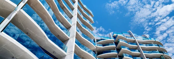 Cropped horizontal image modern blue glass apartments house