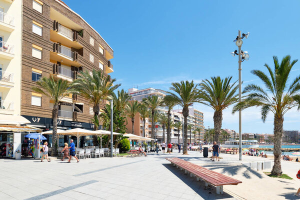 Seafront palm lined promenade near popular Playa del Cura beach 