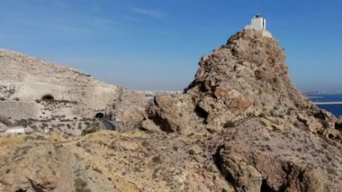 Hava drone noktası Mesa Roldan Lighthouse Akdeniz, ana yol görünümü ve tünel, Cabo de Gata-Nijar Natural Park, Almeria Eyaleti, Endülüs yakın kayalığın üst kenarında yer. İspanya
