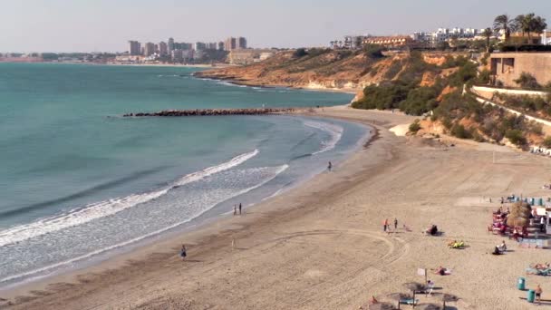人们在卡波罗伊格沙滩享受温暖的天气地中海冲浪 地中海 阳光明媚的日子 奥里韦拉科斯塔在视图上 阿利坎特省 科斯塔布兰卡 西班牙 — 图库视频影像