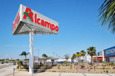 Alcampo signboard near shopping mall La Zenia. Alcampo (Auchan) is a French global retail group, had 639 hypermarkets and 2,412 supermarkets around the world clipart