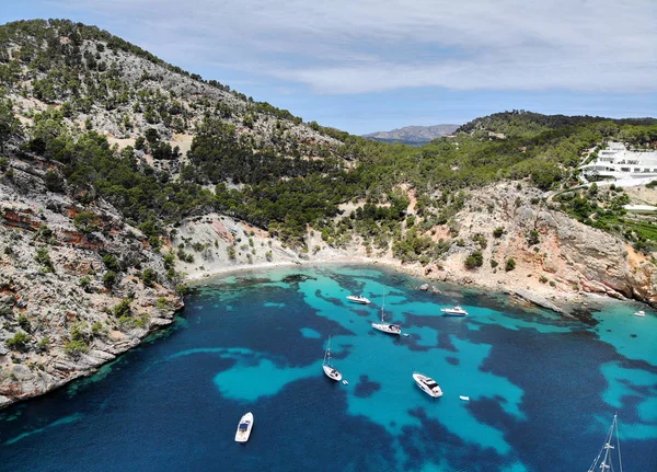Drone point of view aerial photo moored yachts on the bright blue bay on the Cala Blanca Andratx in the Palma de Mallorca