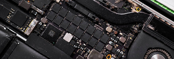 Full frame panorama of disassembled computer electronic device, closeup inside of laptop with lot of dust, need repair clean service conceptual image