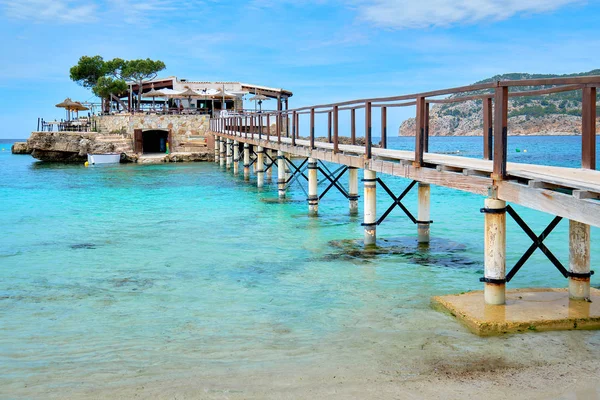 Wooden walkway leading across turquoise Mediterranean Sea