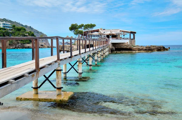 Wooden walkway leading across turquoise Mediterranean Sea