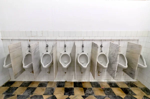 Mens room with white porcelain urinals in a row — Stock Photo, Image
