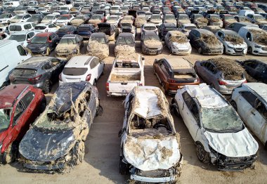 Aerial view new damaged cars due to flooding in dirt, spoiled ca clipart