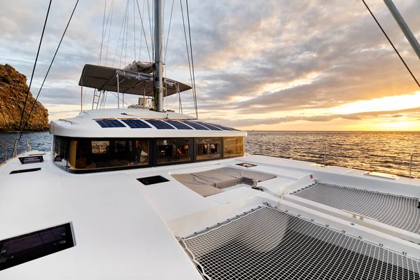 Solar powered catamaran at sunset — Stockfoto