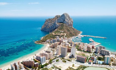Aerial photography Penyal d'Ifac Natural Park, Calpe townscape turquoise bright Mediterranean Sea waters, residential buildings. Province of Alicante, Costa Blanca, Spain. Travel and landmark concept clipart