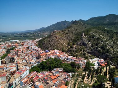 Moixent spanish townscape view from above, picturesque view to mountains and residential buildings drone point of view, sunny summer day. Comarca of Costera in the Valencian Community, Spain clipart