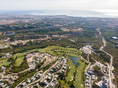 Aerial photo drone point of view golf club with modern villas and apartments on Costa Blanca, Alicante. Sport and recreation tourism concept. Spain clipart