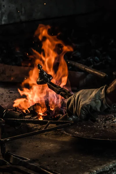 Kalay bakır nesnesiyle ateşte kapsayan geleneksel Türk tenekeci