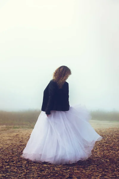 Bride in a black jacket from the back — Stock Photo, Image