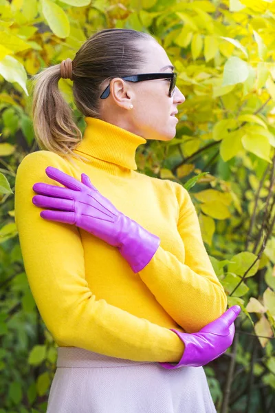 Woman in a bright pink gloves