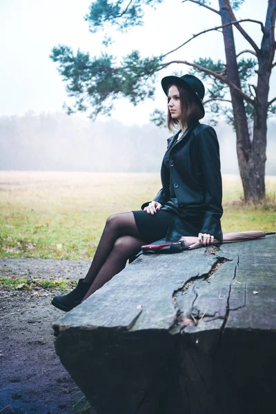 Girl sitting on a bench — Stock Photo, Image