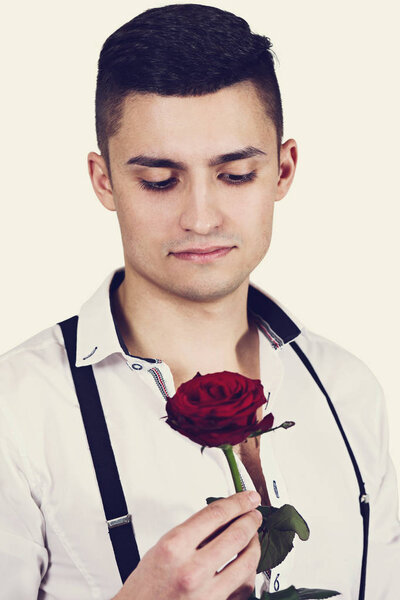A man with red rose in the hands. Valentine day