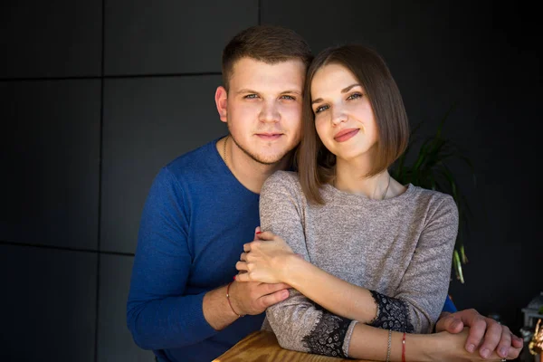 Portrait of a young beautiful couple on a dark background