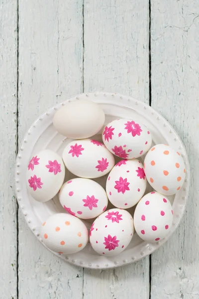 White eggs with pink flowers. Easter food