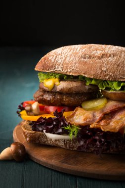 Büyük hamburger domuz pastırması, pirzola ve mantar ile