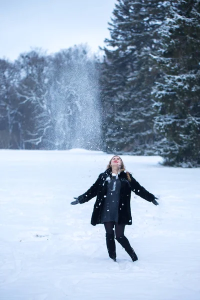 公園で少女が雪と遊んで幸せ — ストック写真