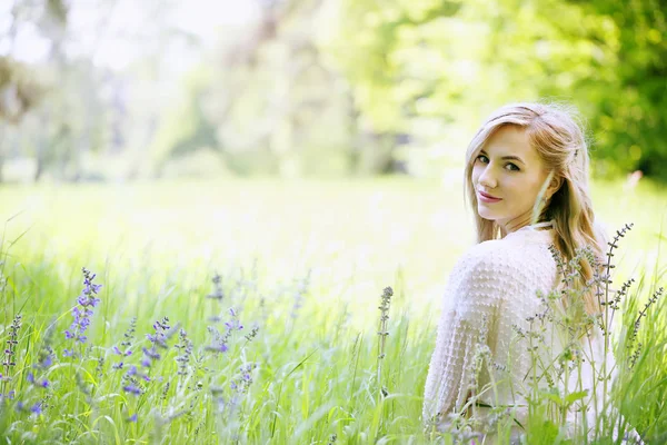 草の中に座っている美しい少女 — ストック写真