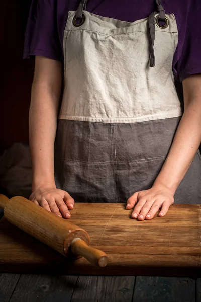 Female hands in front of a cutting board