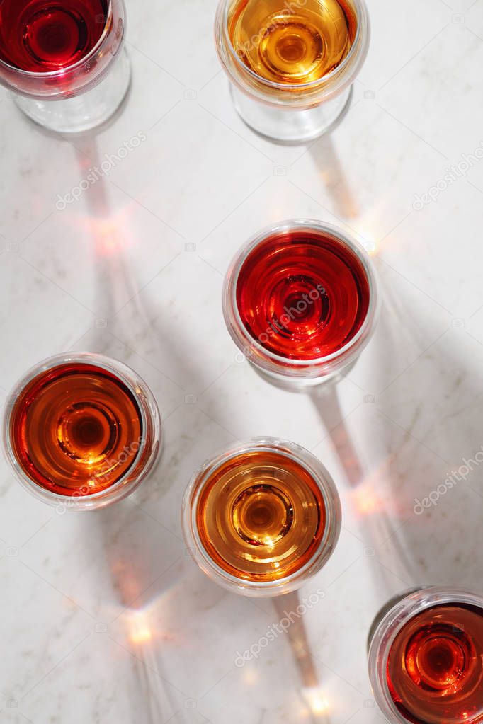 Glass of rose wine on white table