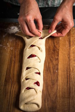 Bir kadın bir rulo hamur dönüyor