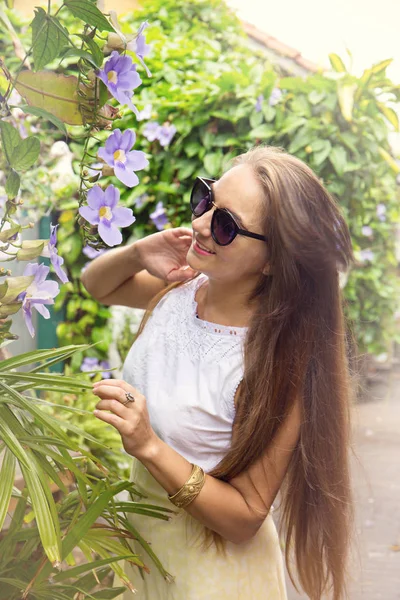 Женщина Нюхает Тропический Цветок Саду — стоковое фото