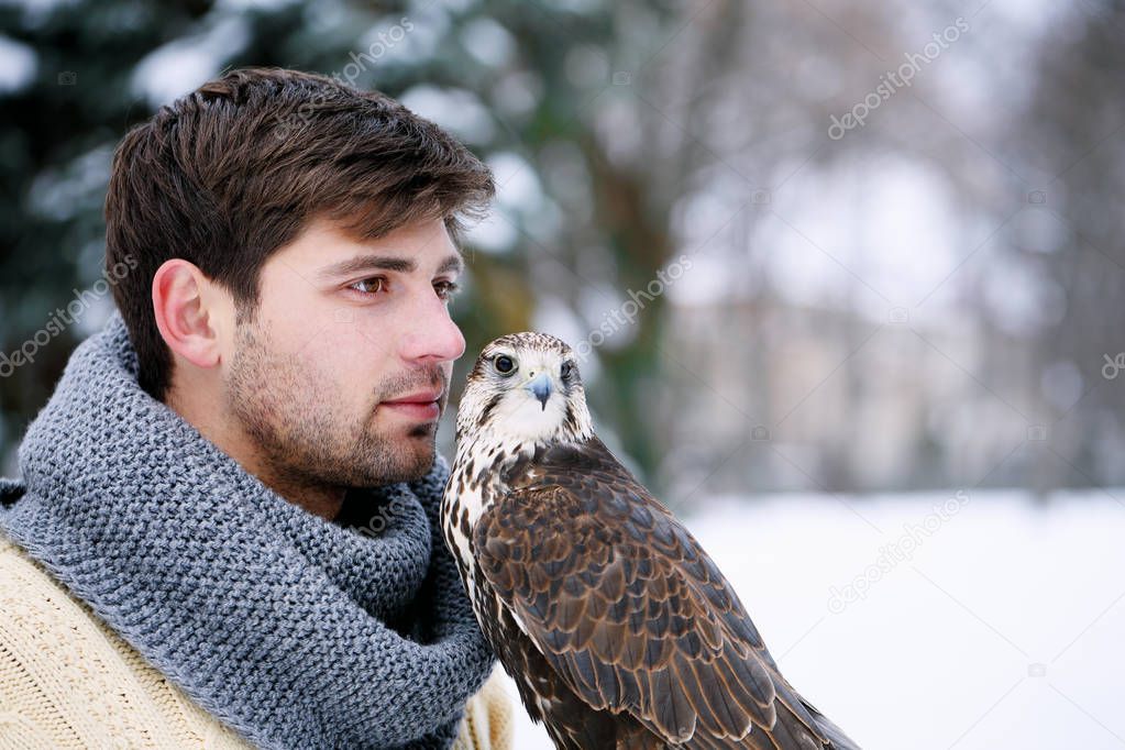 Portrait of a man with a feathered pet
