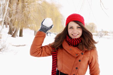 kartopu atarak kırmızı şapkalı kadın