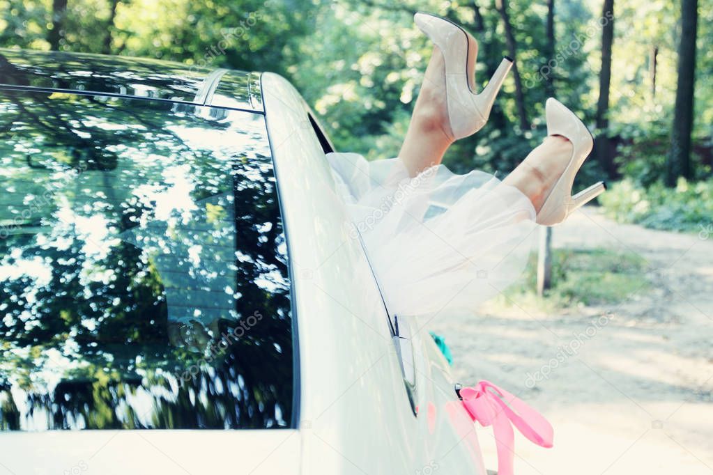 Bride put legs in car window, tinted