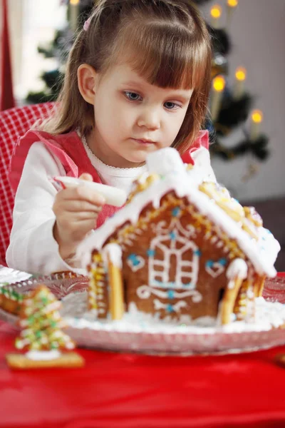 Little Beautiful Girl Decorates Icing Gingerbread House — Stock Photo, Image