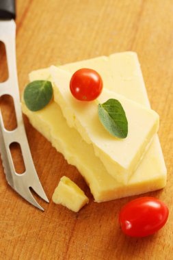 ahşap tahta üzerinde küçük domates peynir parçası