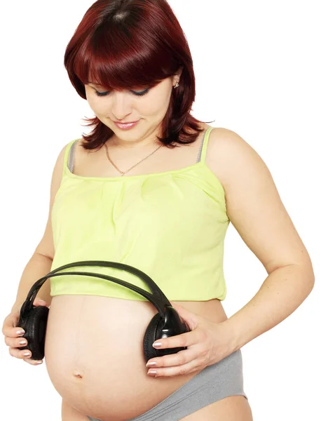 Mujer Embarazada Sostiene Conjuntos Cabeza Cerca Del Estómago — Foto de Stock