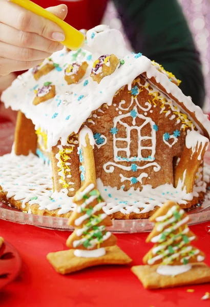 festive gingerbread house decorated with frosting, close-up