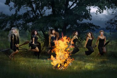 Six witches fly on broomsticks around the campfire at night clipart