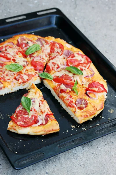 homemade pizza on a black pan