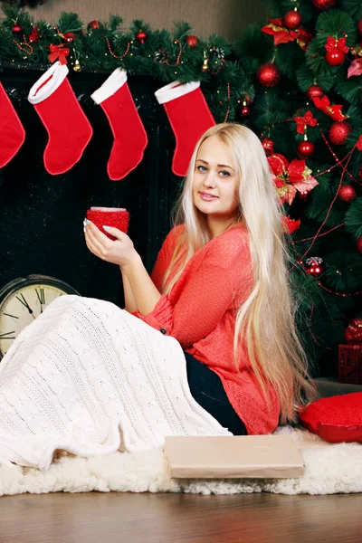 温かい飲み物を飲んで クリスマス ツリーの近くの女性 — ストック写真