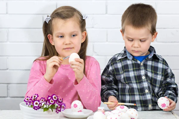 Children paint eggs for the holiday Easter. Easter concept