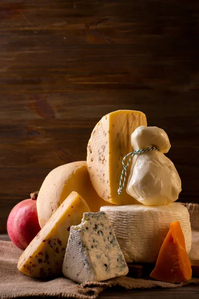 Assorted cheeses and pomegranates — Stock Photo, Image