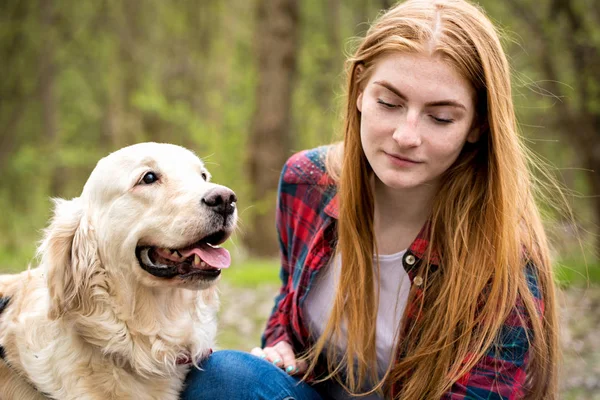 Portrait of a red-haired girl with a dog — Stock Photo, Image