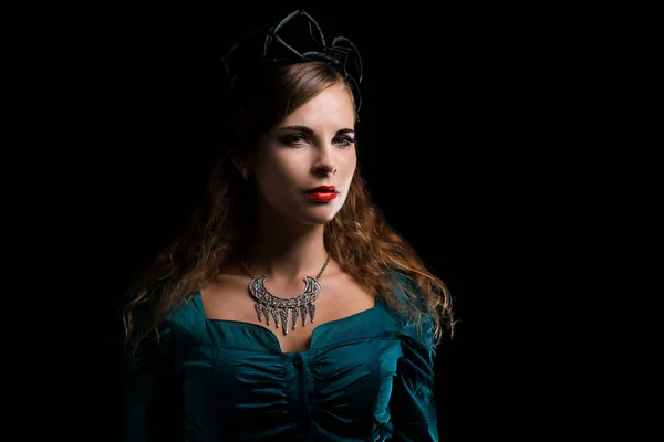 Beautiful young witch in a black crown — Stock Photo, Image