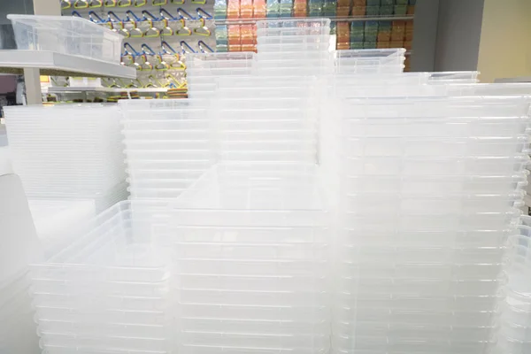 Piles of white transparent plastic containers at exhibition in a