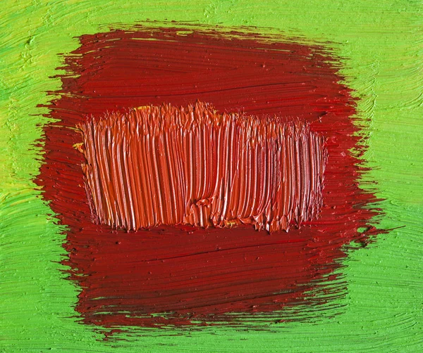 red stroke of the paint brush on green background