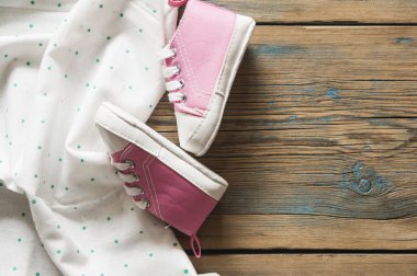 Tatlı küçük bebek patiği yeşil polka dot arka planda, üstten görünüm 