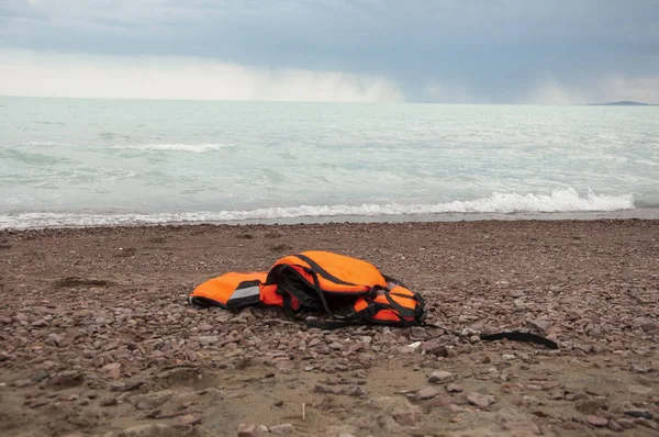 Life jacket laying in the sand on the beach