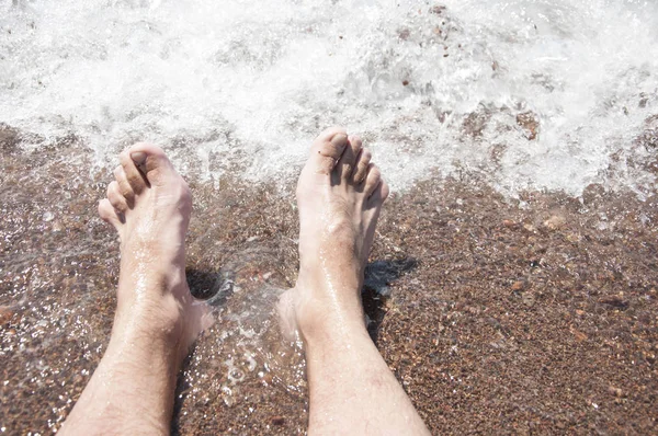 Zbliżenie Stóp Człowieka Stać Wet Plaży Falujący Brzeg Piany Delikatnie Obrazek Stockowy