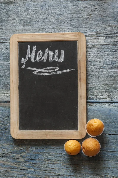 Menu text on a chalkboard on wooden table